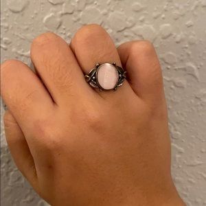 pink with gold feathers around the dainty ring